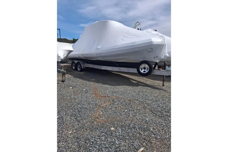 Slide: The Image of 2015 Zodiac 28 Pro Optimum boat on trailer, covered. - 12