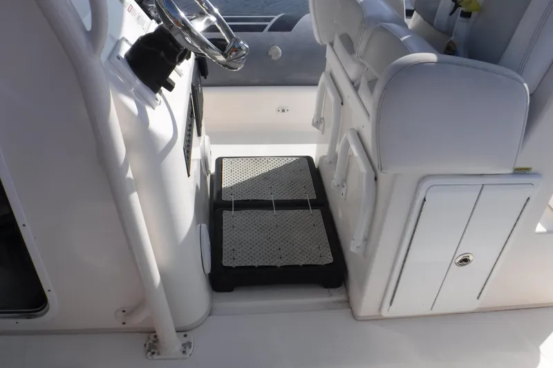 Slide: The Image of Interior of 2015 Zodiac 28 Pro Optimum boat, featuring steering wheel and seating area. - 5
