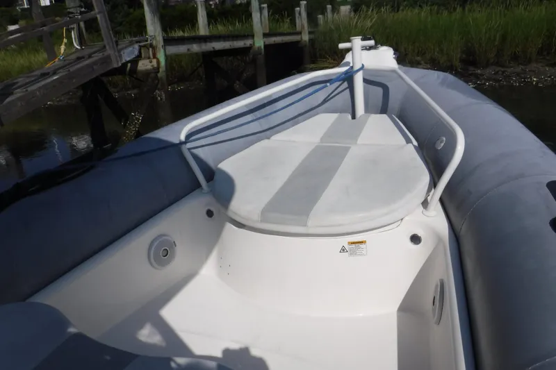 Slide: The Image of 2015 Zodiac 28 Pro Optimum inflatable boat docked near wooden pier. - 8