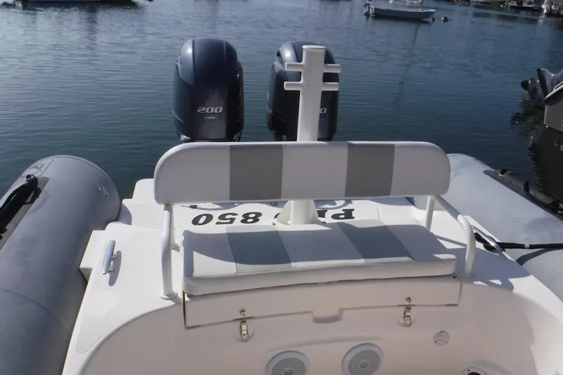 Slide: The Image of 2015 Zodiac 28 Pro Optimum boat with dual Yamaha 200 engines on calm water. - 9