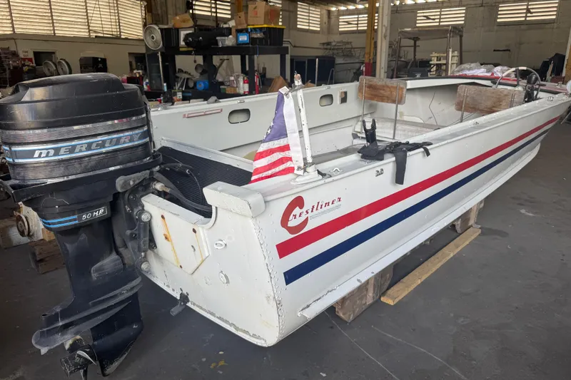 Slide: The Image of 1960 Crestliner Wildwood 19 boat with Mercury 50 HP engine in a workshop. - 12