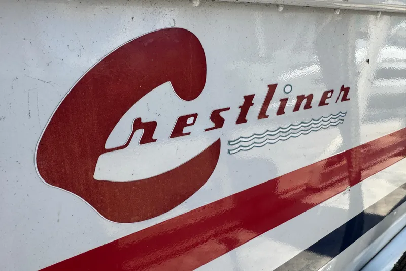 Slide: The Image of 1960 Crestliner Wildwood 19 boat logo with red and white design. - 14