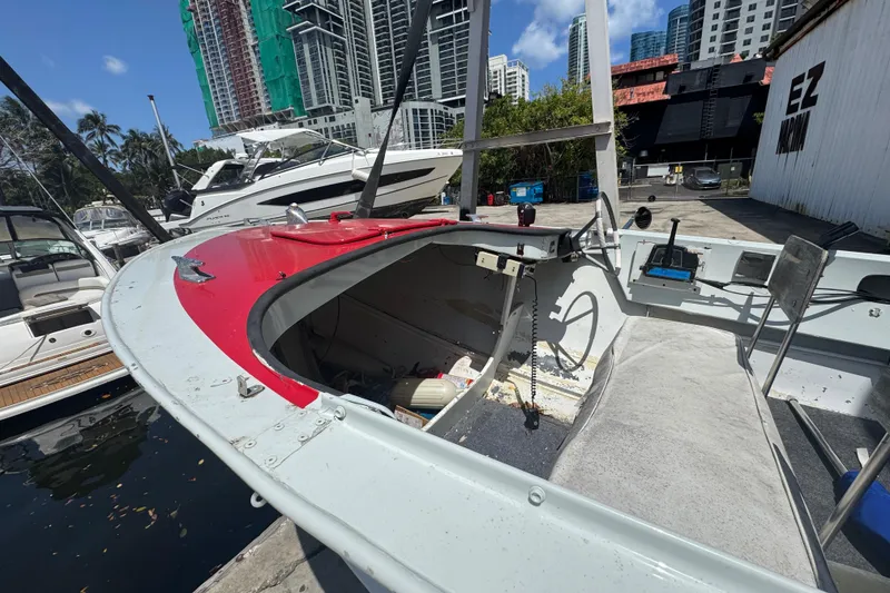Slide: The Image of 1960 Crestliner Wildwood 19 boat docked in urban marina with skyscrapers in background. - 15