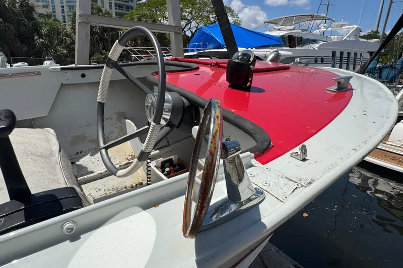 Slide: The Image of 1960 Crestliner Wildwood 19 boat interior with red dashboard and vintage steering wheel. - 21