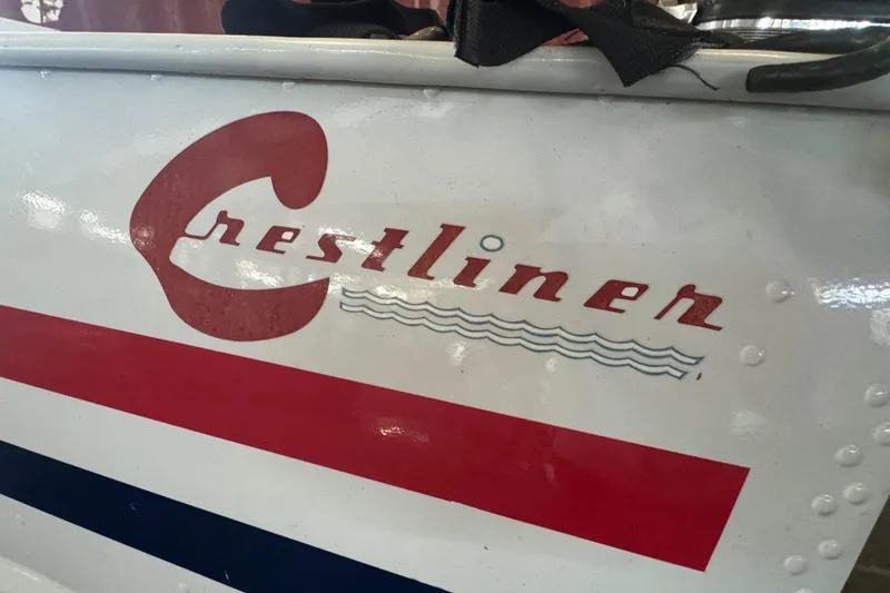 Slide: The Image of 1960 Crestliner Wildwood 19 boat logo with red and blue accents. - 23