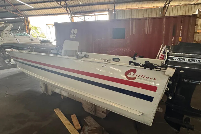 Slide: The Image of 1960 Crestliner Wildwood 19 boat with Mercury outboard motor in a storage facility. - 24