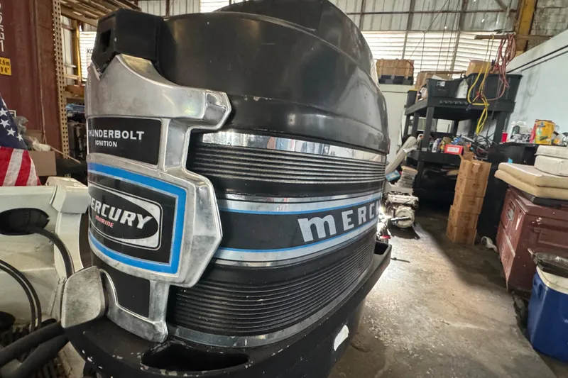 Slide: The Image of 1960 Crestliner Wildwood 19 with Mercury Thunderbolt ignition in a workshop setting. - 25