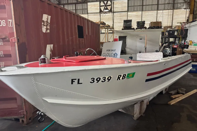 Slide: The Image of 1960 Crestliner Wildwood 19 boat in warehouse, white with red and blue accents. - 26