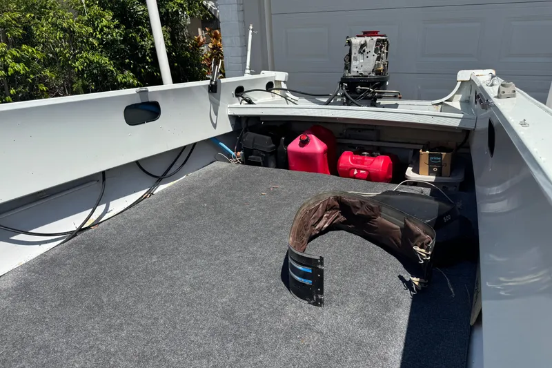 Slide: The Image of 1960 Crestliner Wildwood 19 boat interior with motor, fuel tanks, and storage. - 7