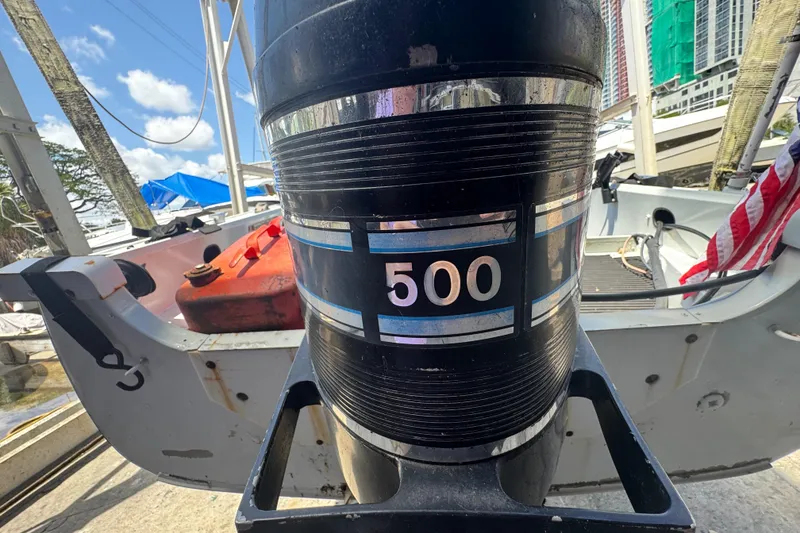 Slide: The Image of 1960 Crestliner Wildwood 19 boat with a "500" labeled outboard motor at a marina. - 8