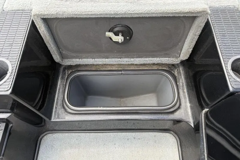 Slide: The Image of Open storage compartment in a 2005 Triton TR 19 X boat. - 11