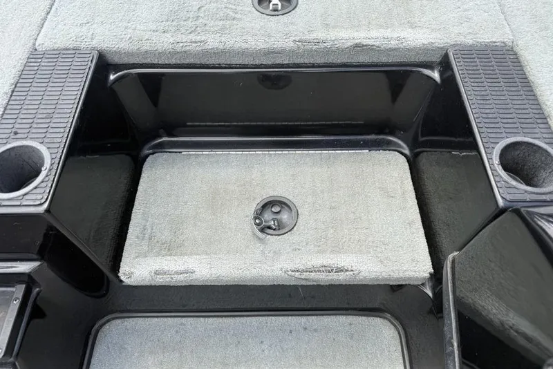 Slide: The Image of Interior of a 2005 Triton TR 19 X boat showing storage compartment and cup holders. - 13