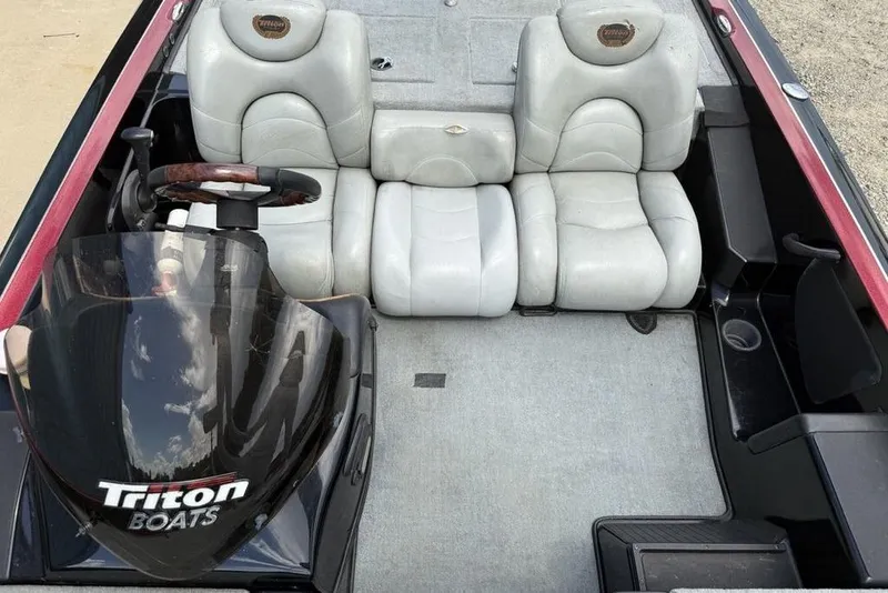 Slide: The Image of 2005 Triton TR 19 X boat interior with gray seats and steering wheel. - 15