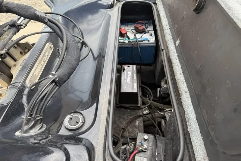 Slide: The Image of 2005 Triton TR 19 X boat battery compartment with wiring and components. - 17