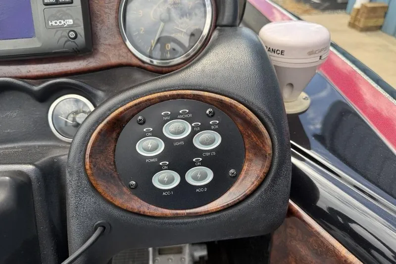 Slide: The Image of Control panel of a 2005 Triton TR 19 X boat with navigation and accessory buttons. - 18
