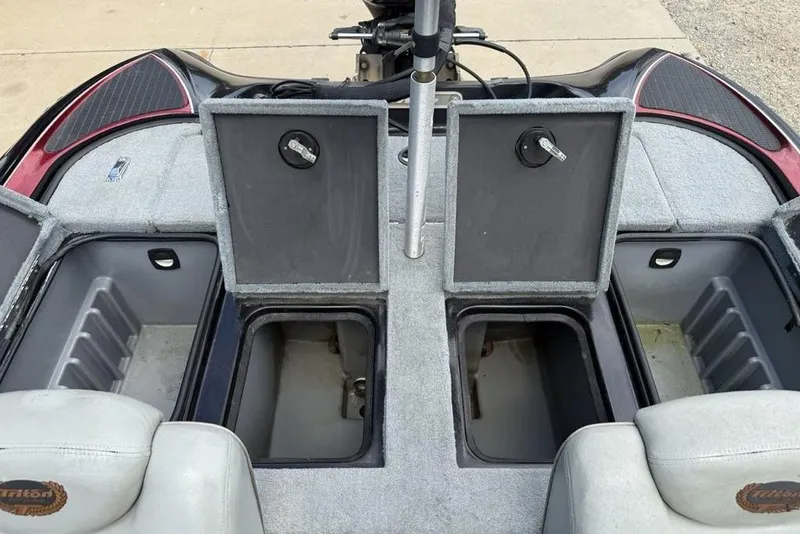 Slide: The Image of 2005 Triton TR 19 X boat interior with open storage compartments. - 19