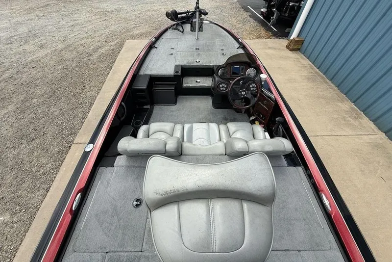 Slide: The Image of 2005 Triton TR 19 X boat interior with gray seating and control panel. - 24