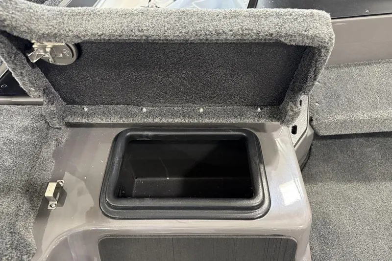 Slide: The Image of Open storage compartment in 2025 Skeeter ZXR20 boat, featuring carpeted interior. - 10