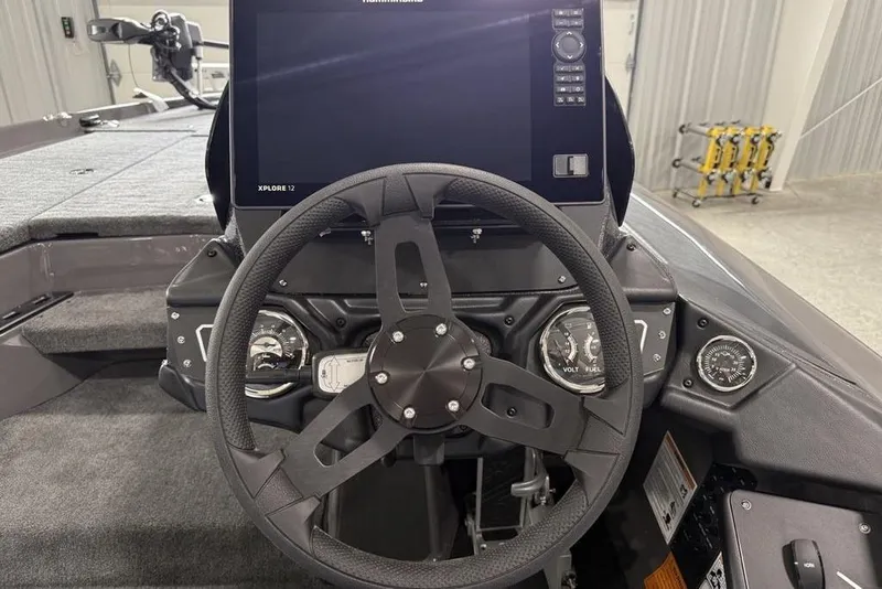Slide: The Image of 2025 Skeeter ZXR20 boat dashboard with steering wheel and digital display. - 15