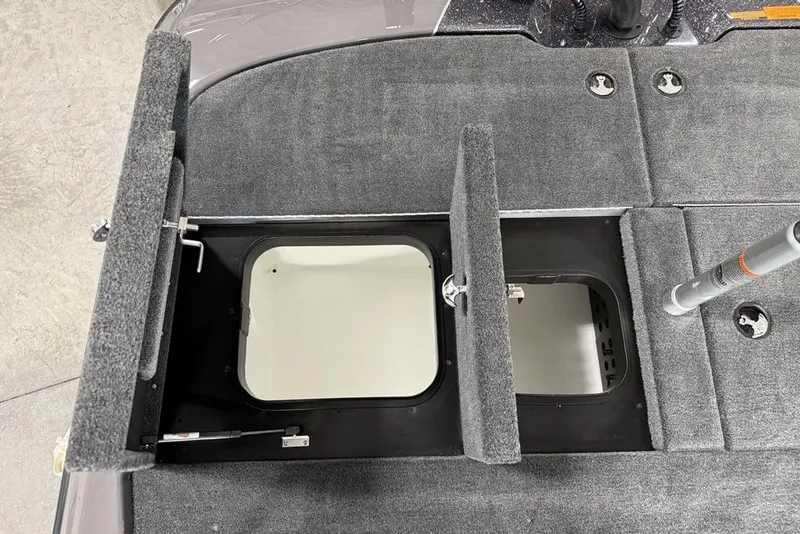 Slide: The Image of 2025 Skeeter ZXR20 boat storage compartments with open hatches, showcasing interior design. - 16