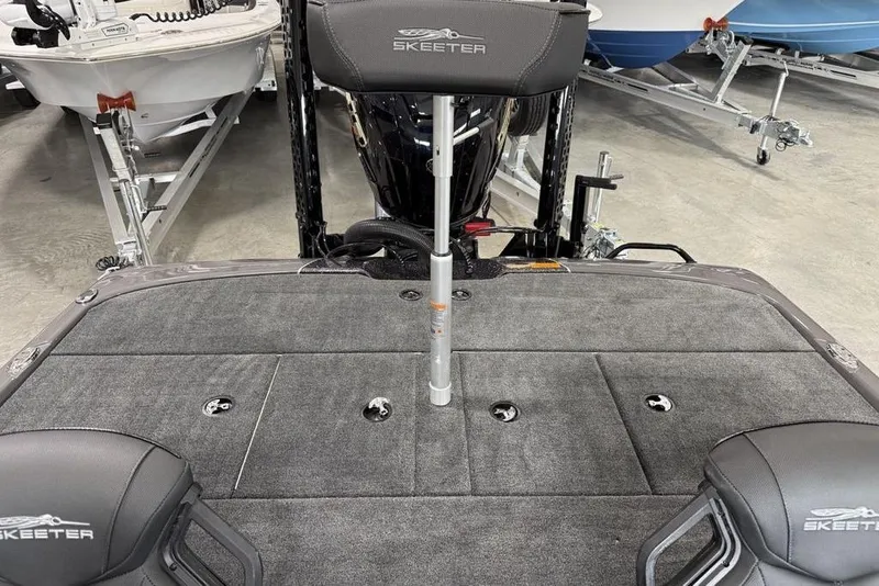 Slide: The Image of 2025 Skeeter ZXR20 boat interior with gray carpet and seating. - 18