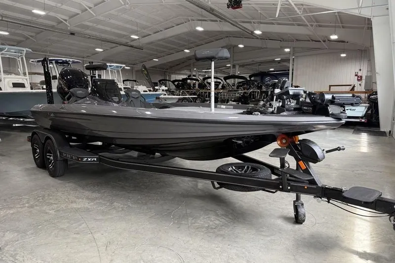 Slide: The Image of 2025 Skeeter ZXR20 boat in showroom, sleek design, on trailer, under bright lighting. - 6