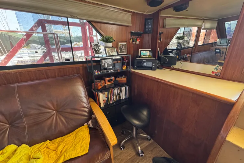 Slide: The Image of Cozy interior of a 1986 Californian 42 yacht with leather seating and wooden decor. - 16