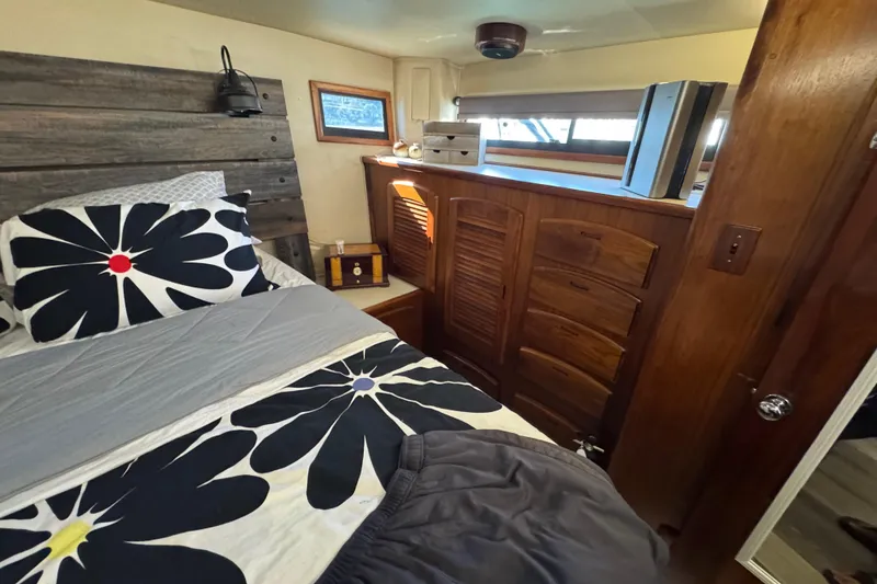 Slide: The Image of Cozy bedroom in 1986 Californian 42 yacht with floral bedding and wooden cabinetry. - 19