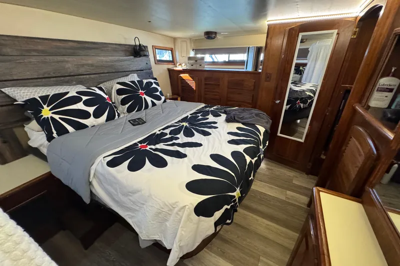Slide: The Image of Cozy bedroom in 1986 Californian 42 yacht with floral bedding and wooden accents. - 24