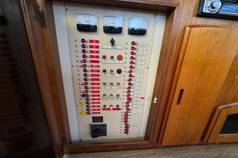 Slide: The Image of Electrical panel on a 1986 Californian 42 yacht, featuring switches and gauges. - 28