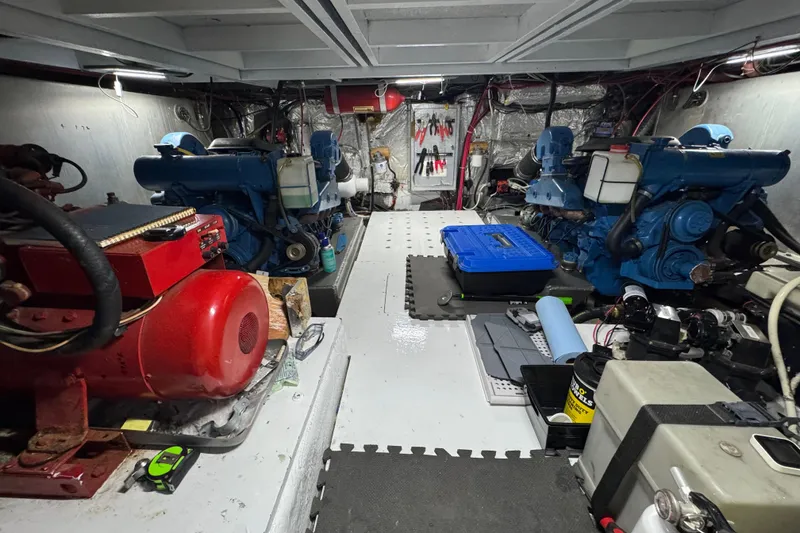 Slide: The Image of Engine room of a 1986 Californian 42 yacht with blue and red machinery. - 29