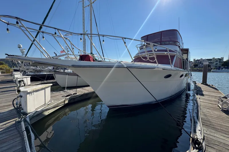 Slide: The Image of 1986 Californian 42 yacht docked at marina under clear blue sky. - 3