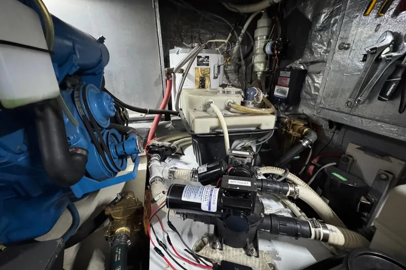 Slide: The Image of Engine room of a 1986 Californian 42 yacht with visible machinery and tools. - 31