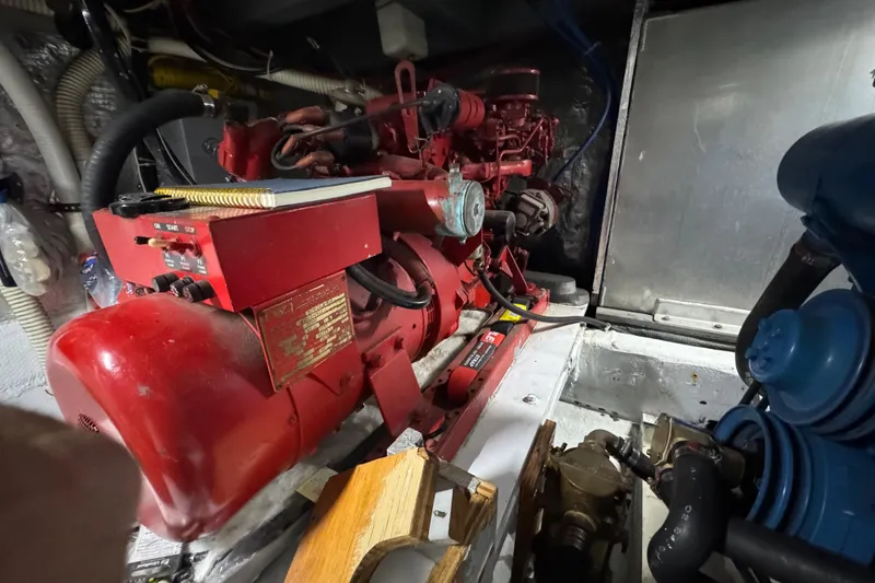 Slide: The Image of Engine room of a 1986 Californian 42 yacht with red machinery and components. - 33