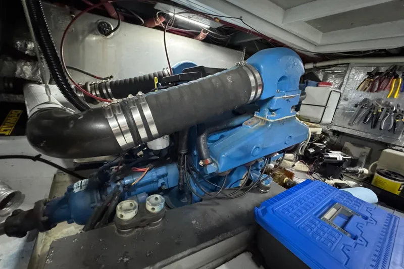 Slide: The Image of Engine room of a 1986 Californian 42 yacht with blue machinery and tools. - 35
