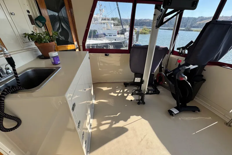 Slide: The Image of Interior of a 1986 Californian 42 boat with exercise bike and kitchenette. - 37