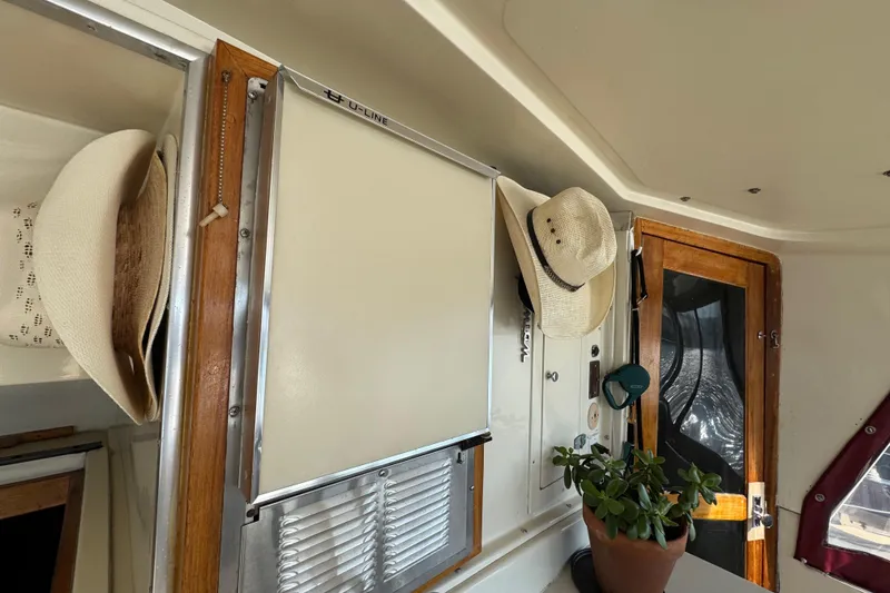 Slide: The Image of Interior of 1986 Californian 42 boat with hats and plant decor. - 38