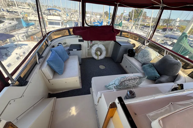 Slide: The Image of Luxurious 1986 Californian 42 yacht interior with plush seating and marina view. - 40