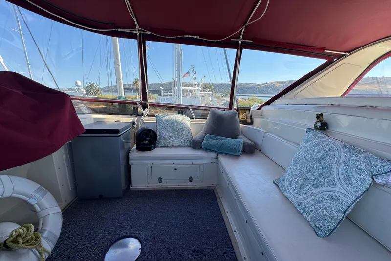 Slide: The Image of Interior of 1986 Californian 42 yacht with cozy seating and scenic marina view. - 43