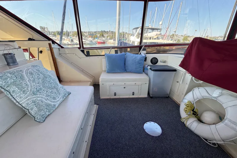 Slide: The Image of Interior of 1986 Californian 42 yacht with seating, cushions, and marina view. - 44