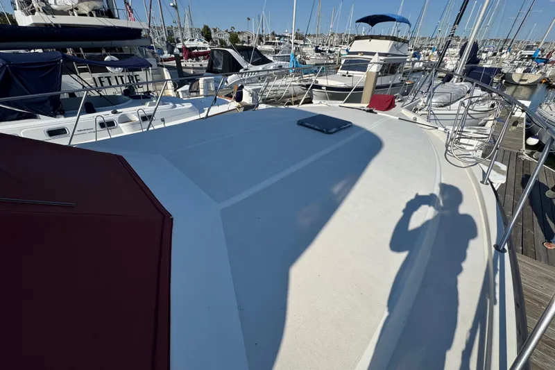 Slide: The Image of 1986 Californian 42 yacht deck in marina, surrounded by various boats. - 49