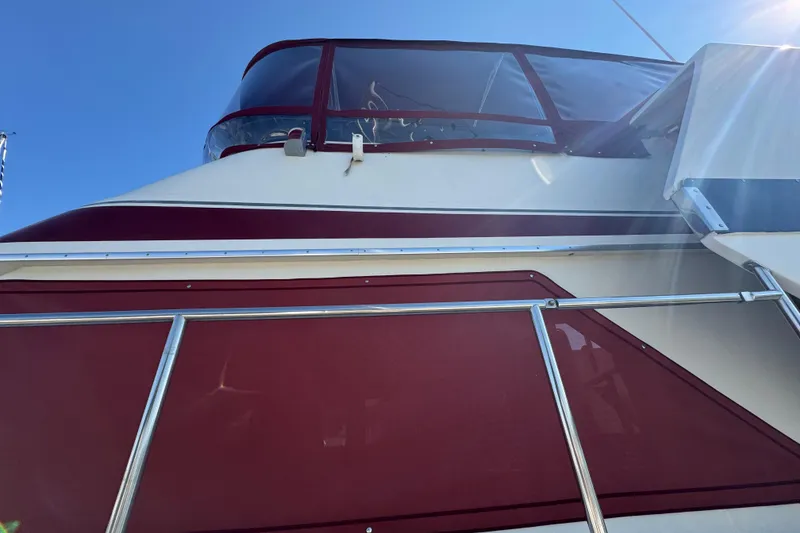 Slide: The Image of 1986 Californian 42 yacht with red and white exterior, viewed from below. - 5