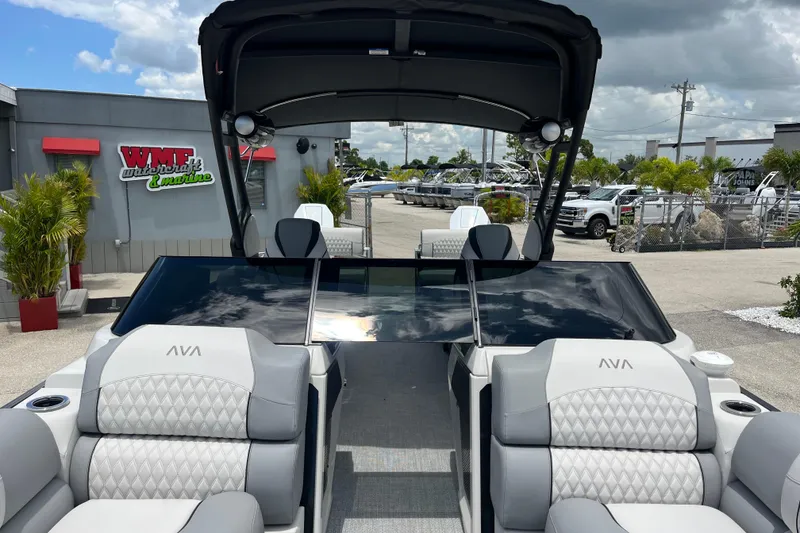 Slide: The Image of 2026 Avalon 2785 Excalibur LTD boat with windshield, quad lounger, and twin Mercury engines. - 18