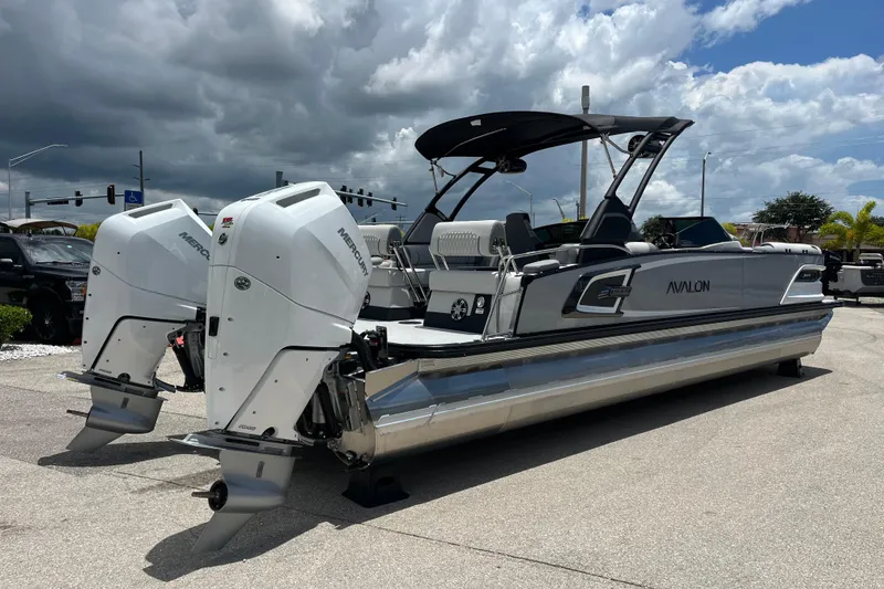 Slide: The Image of 2026 Avalon 2785 Excalibur LTD boat with twin Mercury 400hp engines, parked outdoors. - 5