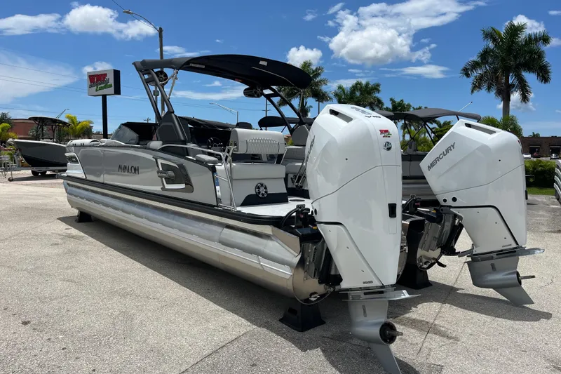 Slide: The Image of 2026 Avalon 2785 Excalibur LTD boat with twin Mercury 400hp engines, parked outdoors. - 7