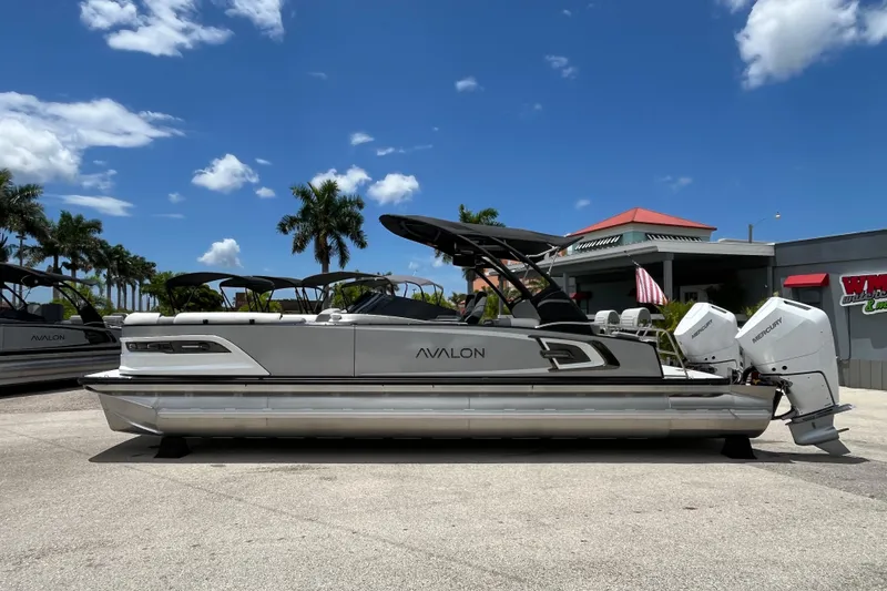 Slide: The Image of Avalon 2785 Excalibur LTD boat with twin Mercury 400hp engines, parked outdoors, 2026 model. - 8