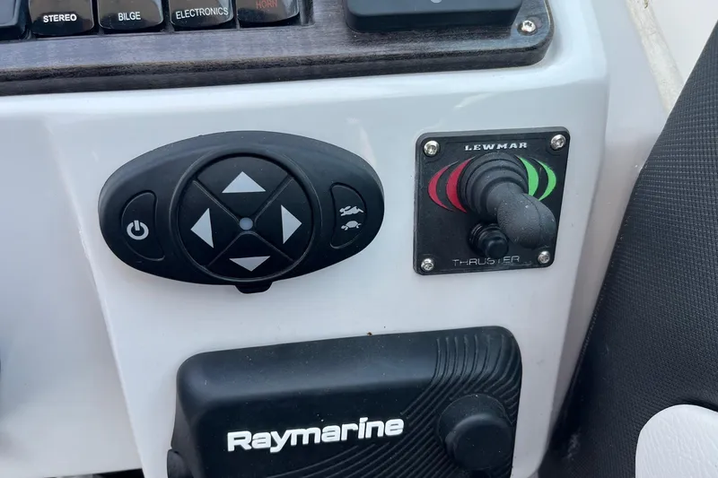 Slide: The Image of Control panel of a 2020 Rinker 290 EX boat with Lewmar thruster and Raymarine equipment. - 16