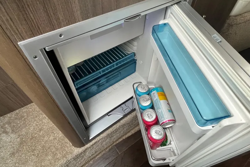 Slide: The Image of Open mini fridge in 2020 Rinker 290 EX boat with drinks inside. - 23