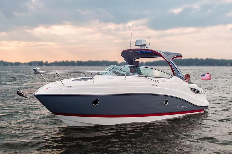 Slide: The Image of Manufacturer Provided Image: 2020 Rinker 290 EX boat cruising on a lake at sunset. - 29