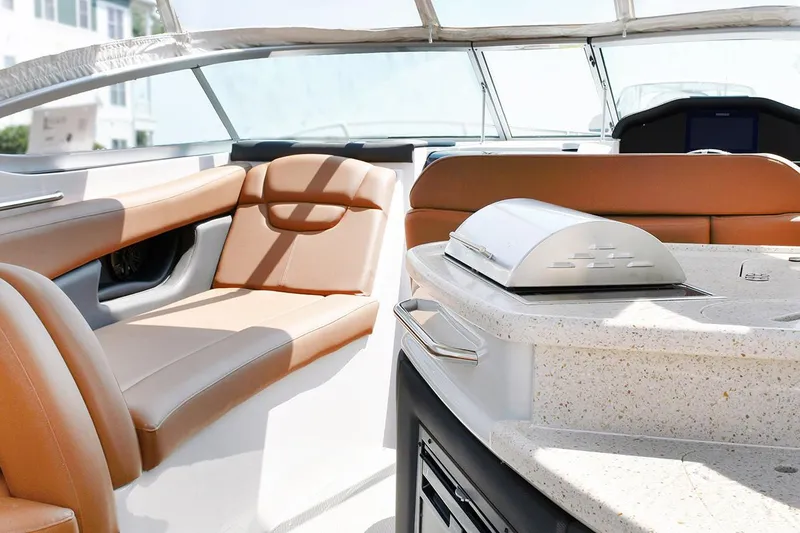Slide: The Image of Manufacturer Provided Image: Interior of 2020 Rinker 290 EX boat with tan leather seating and kitchenette. - 33